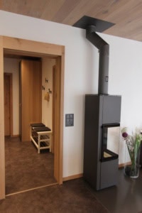 wohnbereich mit kamin und eingang ferienwohnung san nazzaro lago maggiore tessin